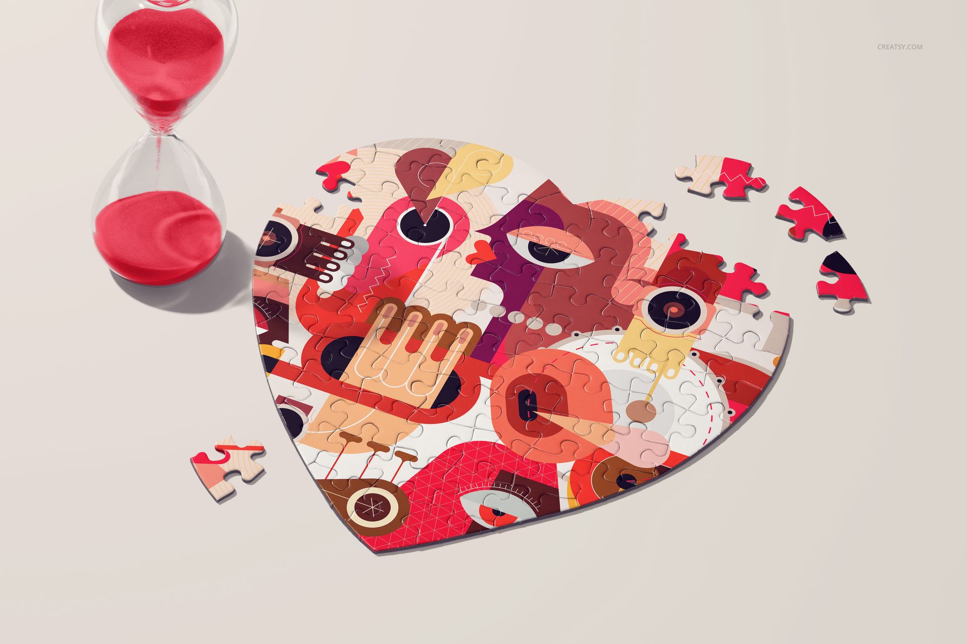Heart jigsaw puzzle mockup featuring vibrant geometric artwork, several loose pieces, and a red sand hourglass nearby.