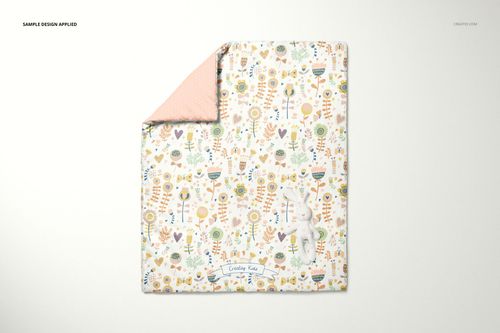Baby duvet cover mockup featuring a playful botanical print, pink reverse corner, and white stuffed bunny on light background.