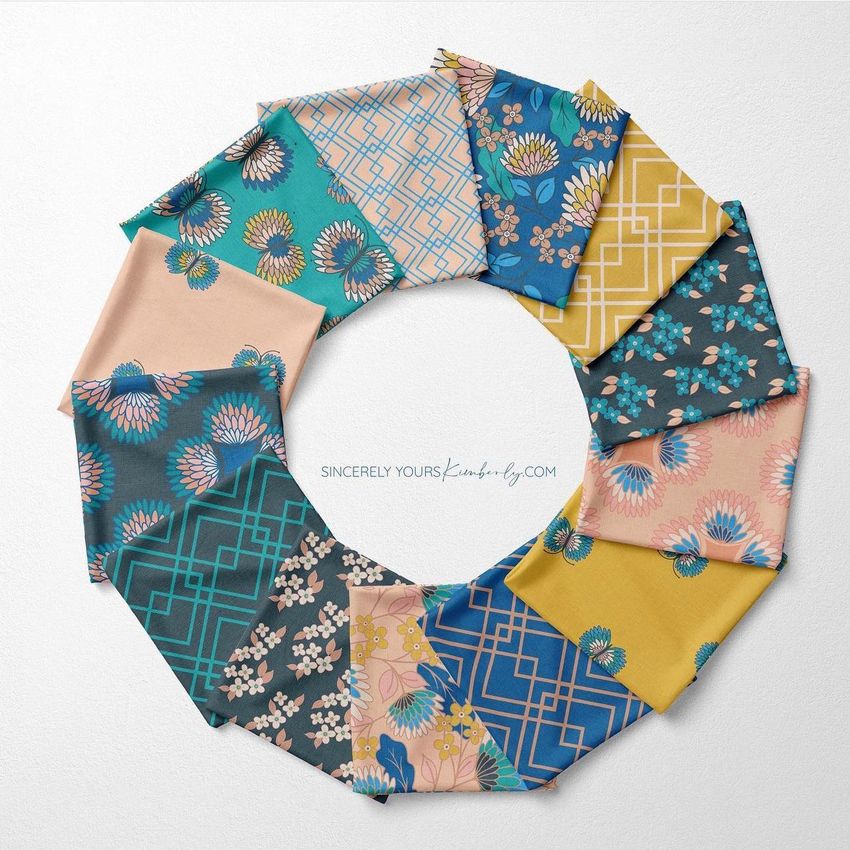 Folded fabrics mockup showing a circular arrangement of patterned fabric squares in teal, pink, yellow, and blue tones on a white surface.