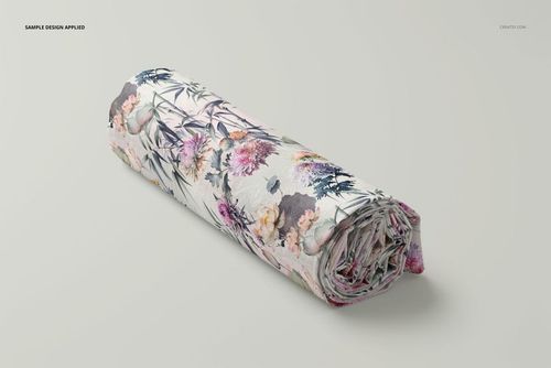 Rolled fabric mockup with botanical design in pastel colors, shown from an angled side view on a plain surface.