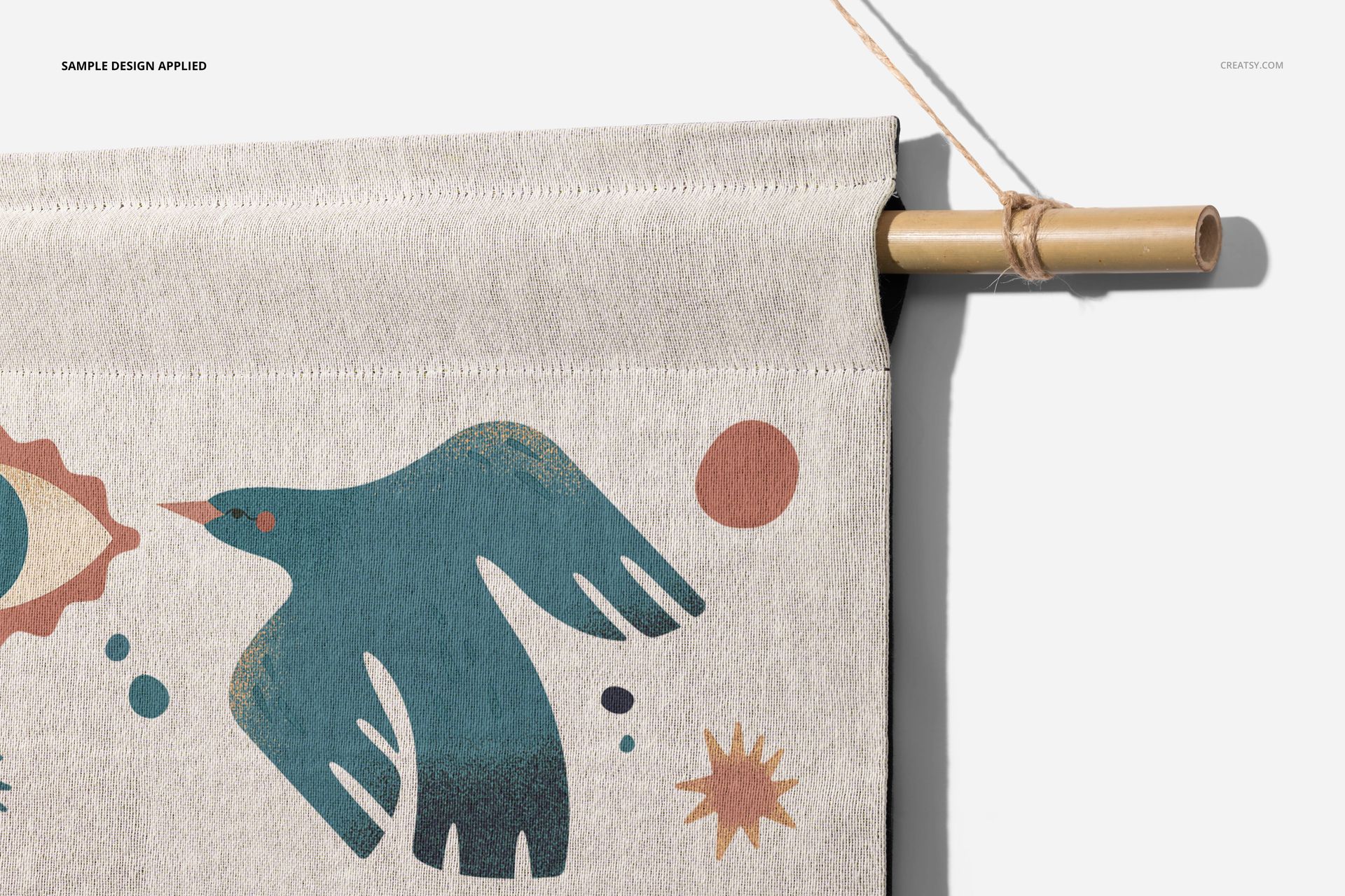 Close-up front view of a woven wall tapestry mockup featuring a blue bird and abstract shapes on light fabric.