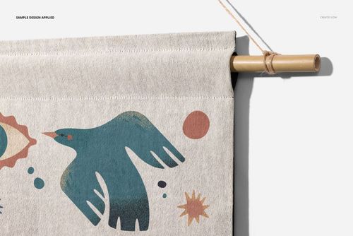 Close-up front view of a woven wall tapestry mockup featuring a blue bird and abstract shapes on light fabric.