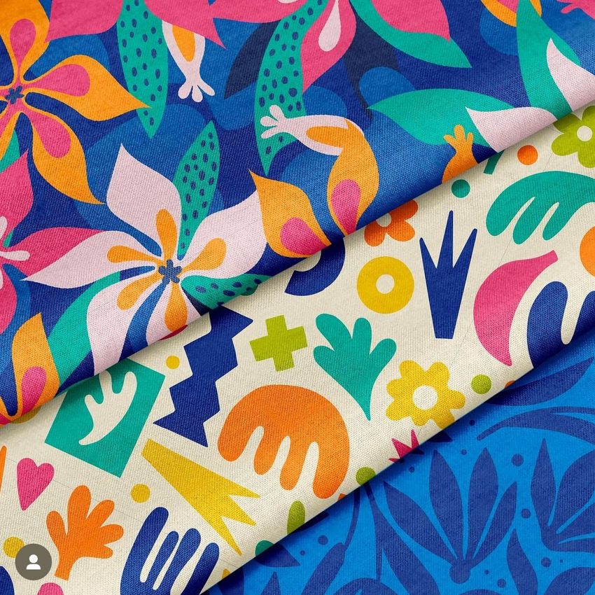 Cotton fabric mockup with two folded pieces, one featuring a colorful floral pattern and the other abstract shapes.