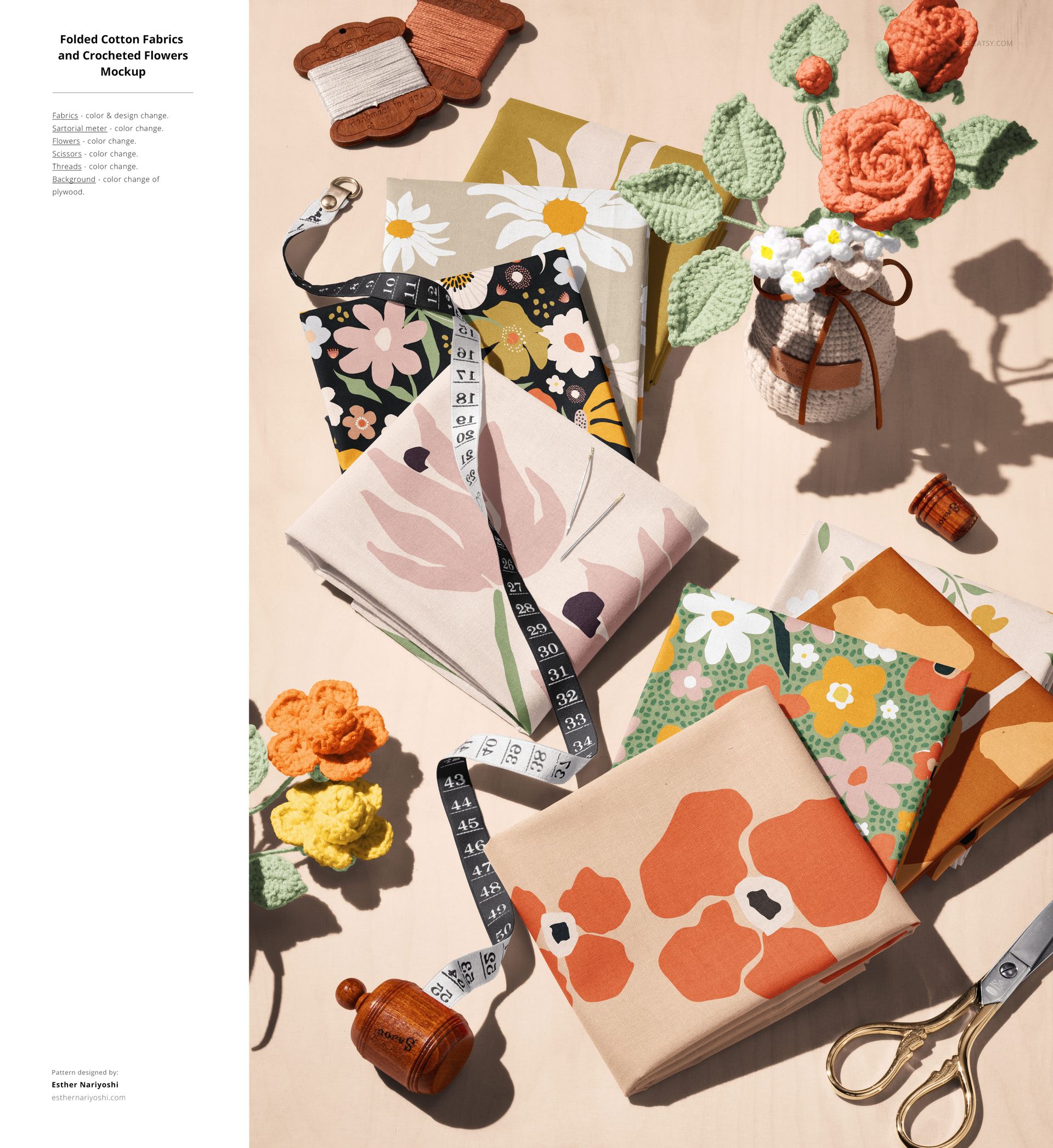 Cotton fabric mockup featuring folded textiles with bright flower designs, alongside pins, thread, and decorative props.