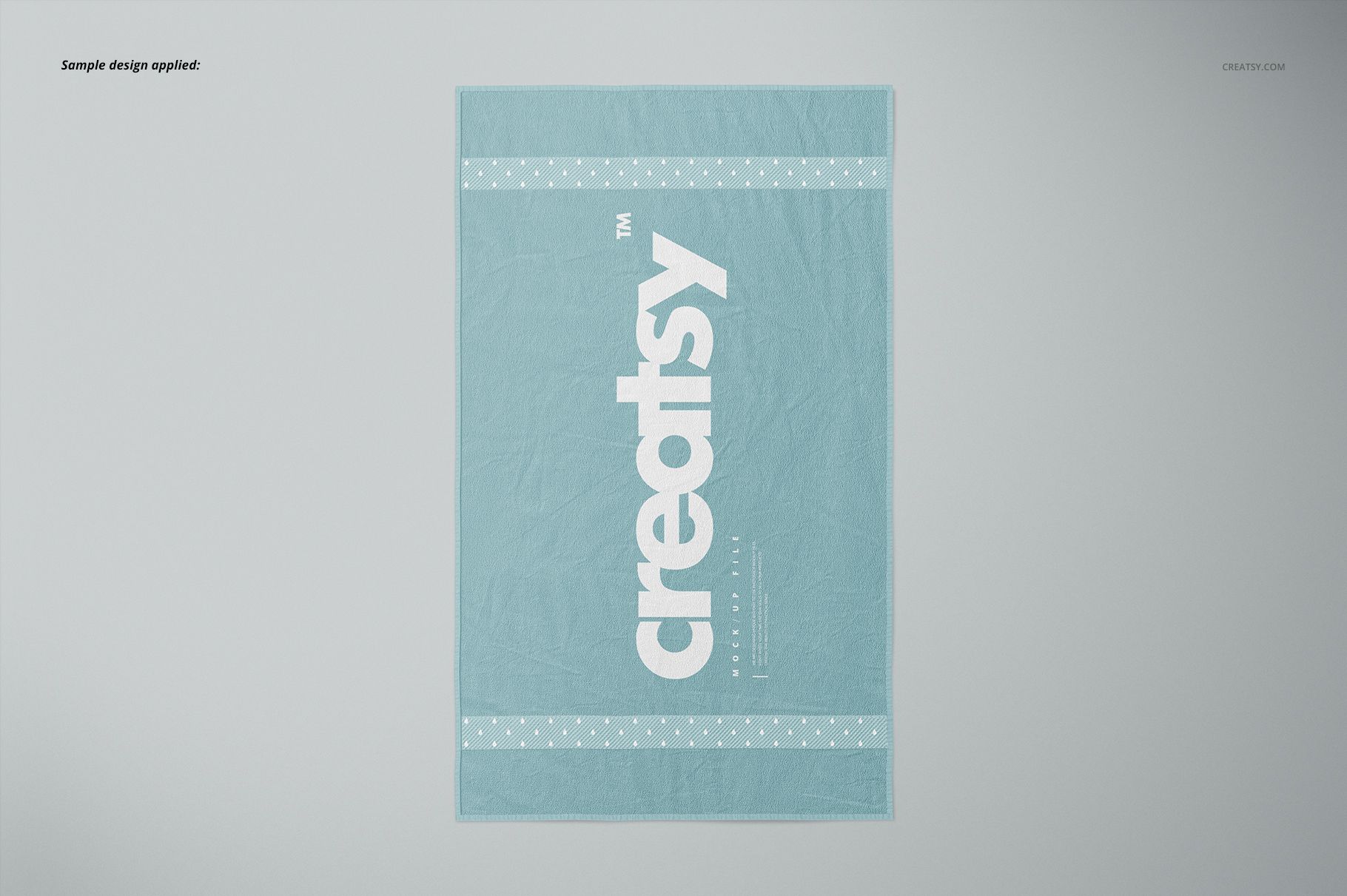 Bath towel mockup featuring a soft blue color, white branding, and polka dot accents, shown in a flat lay perspective.