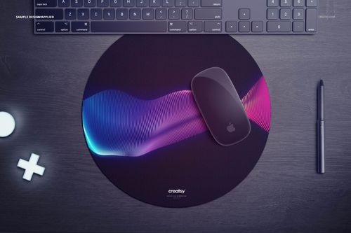 Circular mouse pad mockup featuring a vibrant blue and pink gradient design, top view with tech accessories nearby.