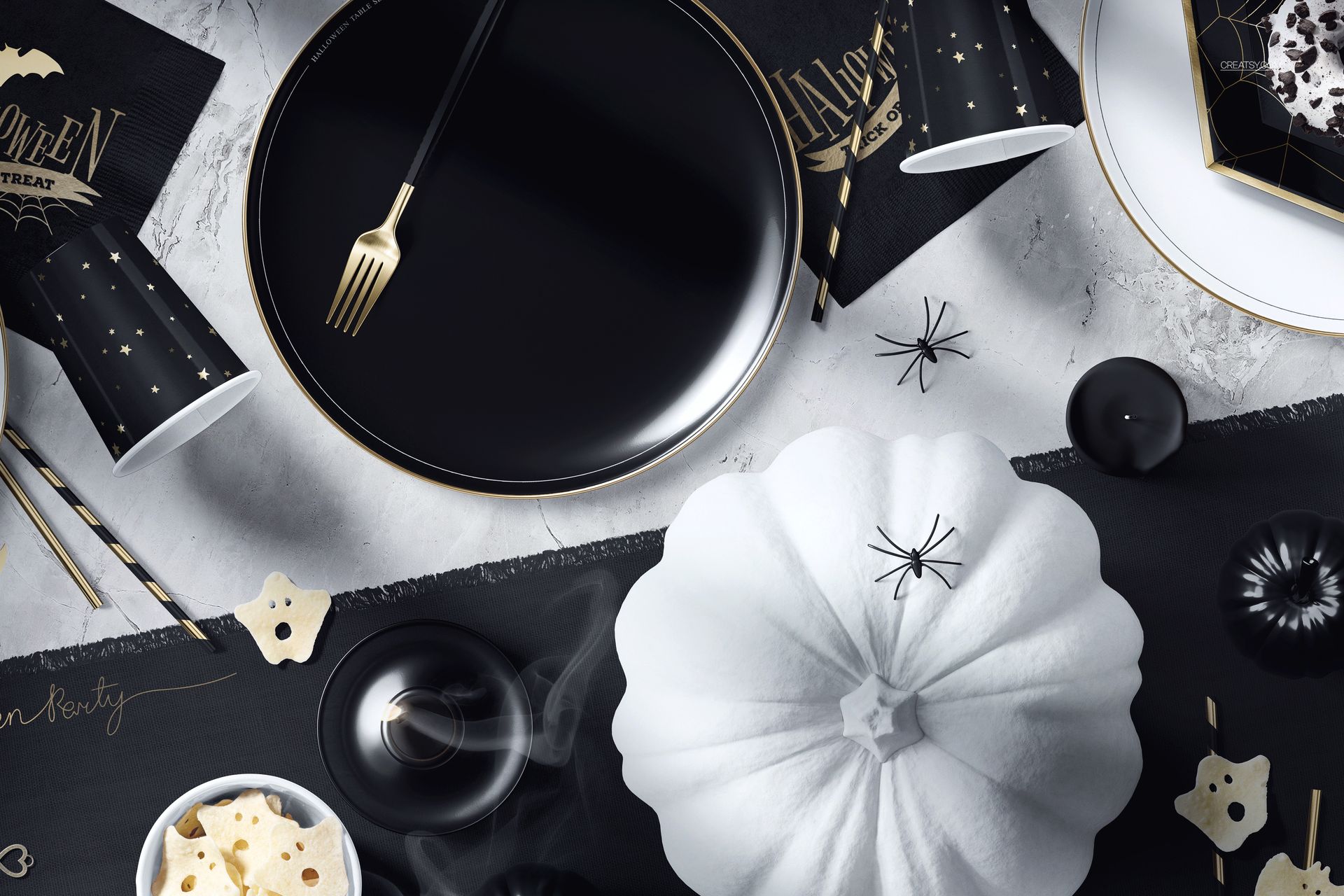 Top view of a Halloween table setup mockup with black plates, gold cutlery, white pumpkin, and themed decorations.