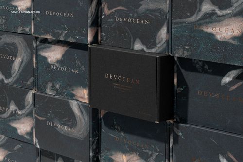 PSD mockup of multiple packaging boxes arranged in a grid, featuring dark abstract patterns and metallic text.