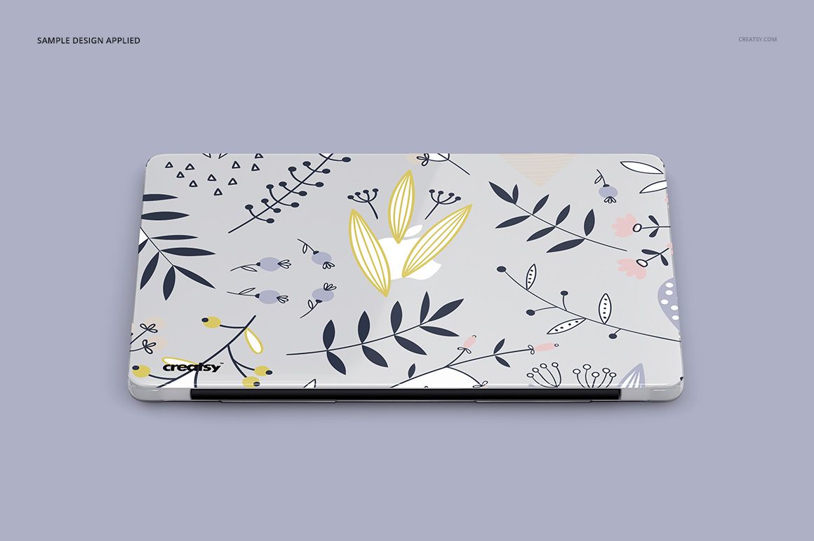 PSD mockup of a Macbook with a clear protective case decorated with whimsical botanical illustrations, viewed from above.