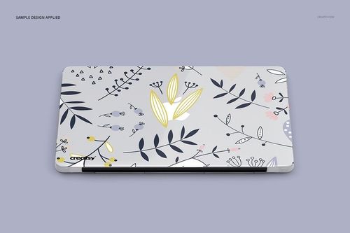 PSD mockup of a Macbook with a clear protective case decorated with whimsical botanical illustrations, viewed from above.