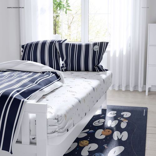 Mockup of a kids bed set featuring navy blue striped pillowcases and sheet, with white patterned fitted sheet.
