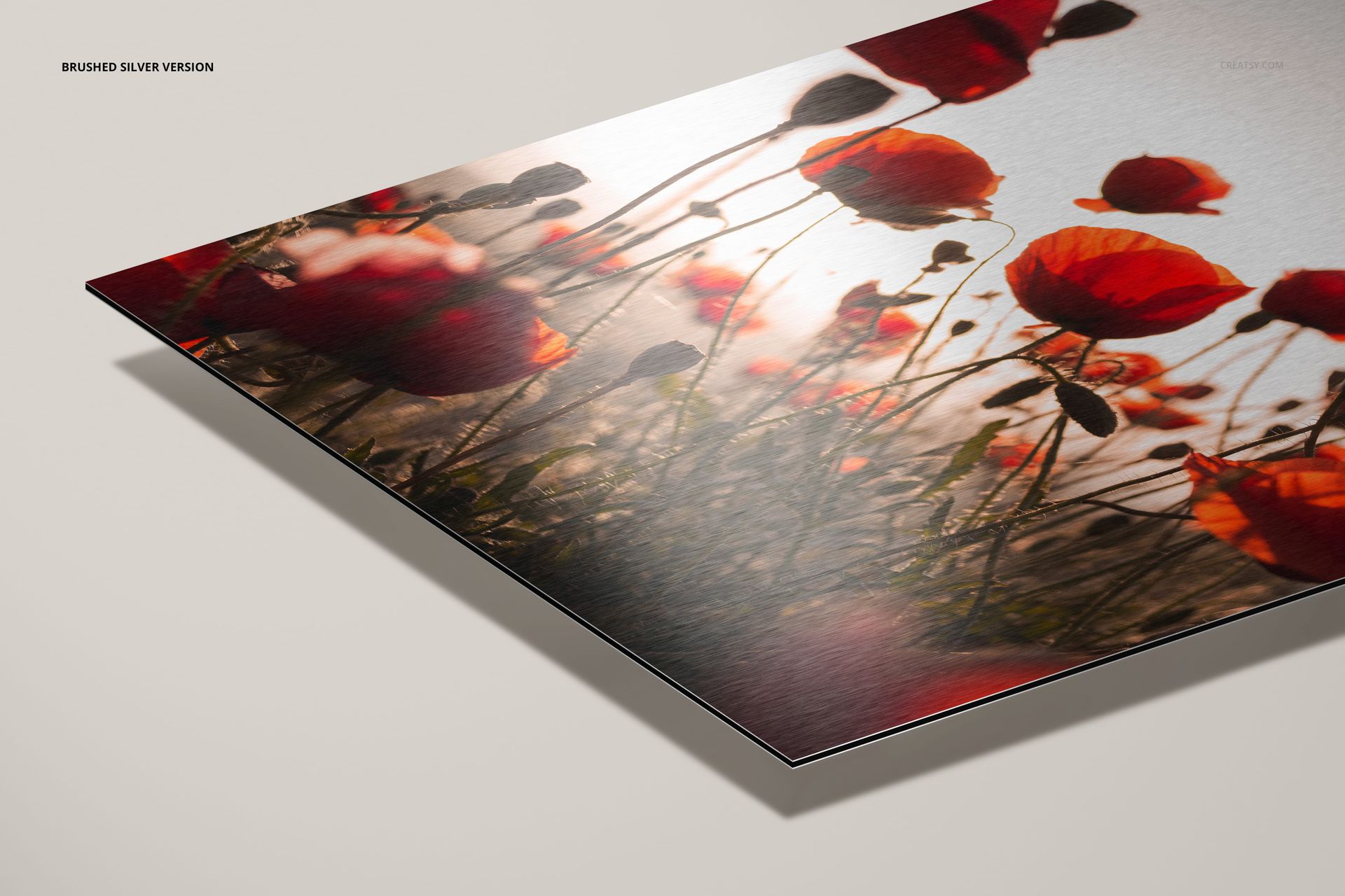 Detailed perspective of a brushed silver dibond aluminum mockup displaying a floral print with red poppies.