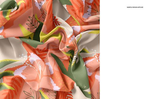 Close-up of silk fabric mockup featuring a colorful floral pattern with orange, green, and pink accents, crumpled texture.