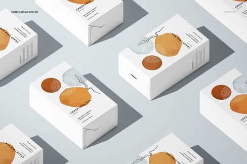 Packaging mockup set showing several rectangular boxes with modern abstract prints, displayed on a pale background.