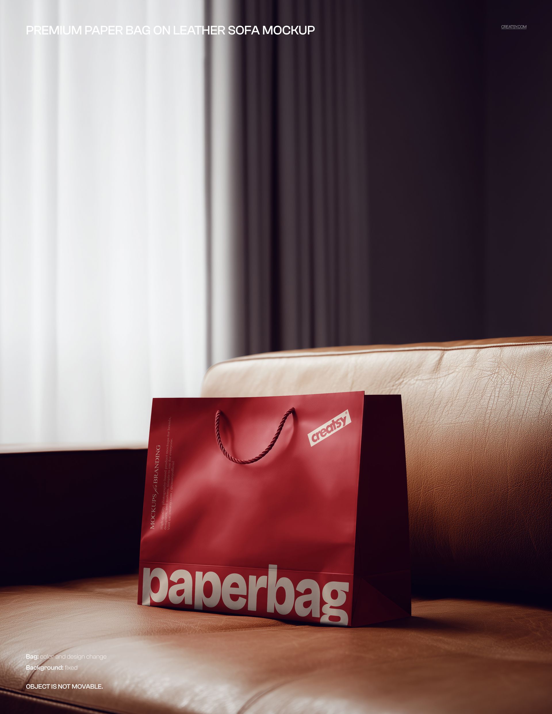 Front view of a red paper bag mockup with prominent white text, positioned on a beige leather sofa indoors.