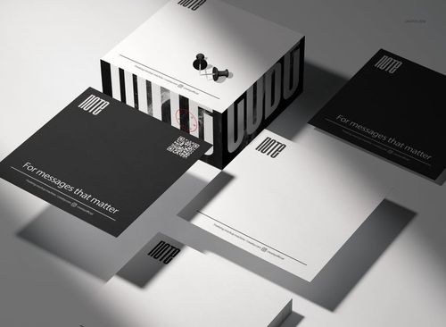 Stationery note cube mockup set with black and white square sheets, box packaging, and push pins in a studio setting.