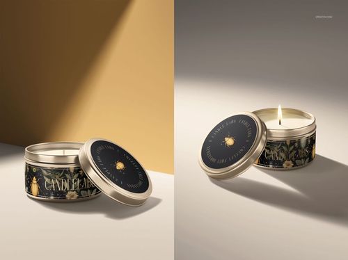 Mockup of a small round candle tin with decorative floral design, one tin open with lit candle, one closed.