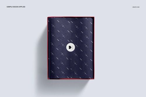 Top view of a shoe box mockup with a navy blue patterned tissue paper inside, closed with a round white sticker, on a light background.