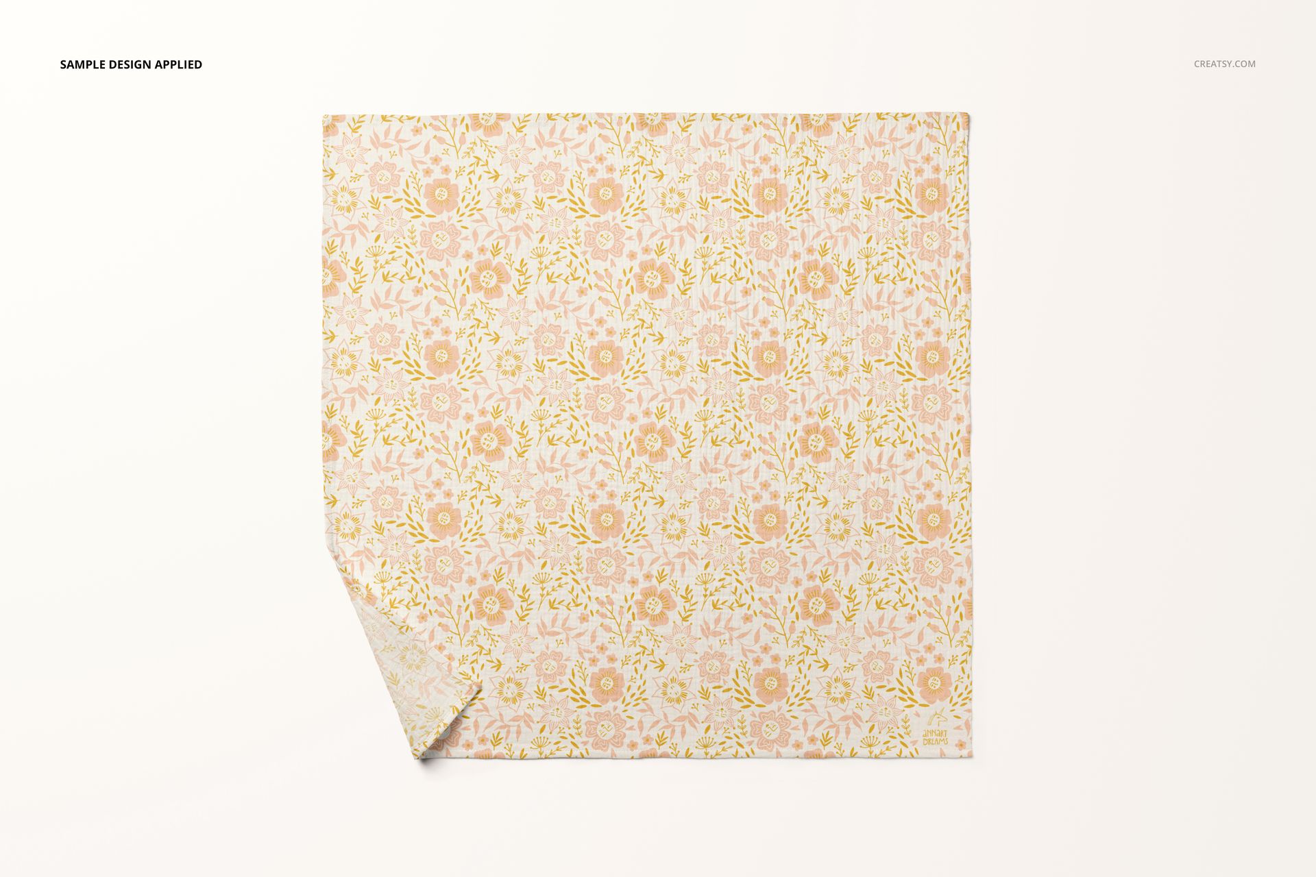 Top view of a crinkle muslin swaddle blanket mockup featuring a repeating pink and yellow flower design.