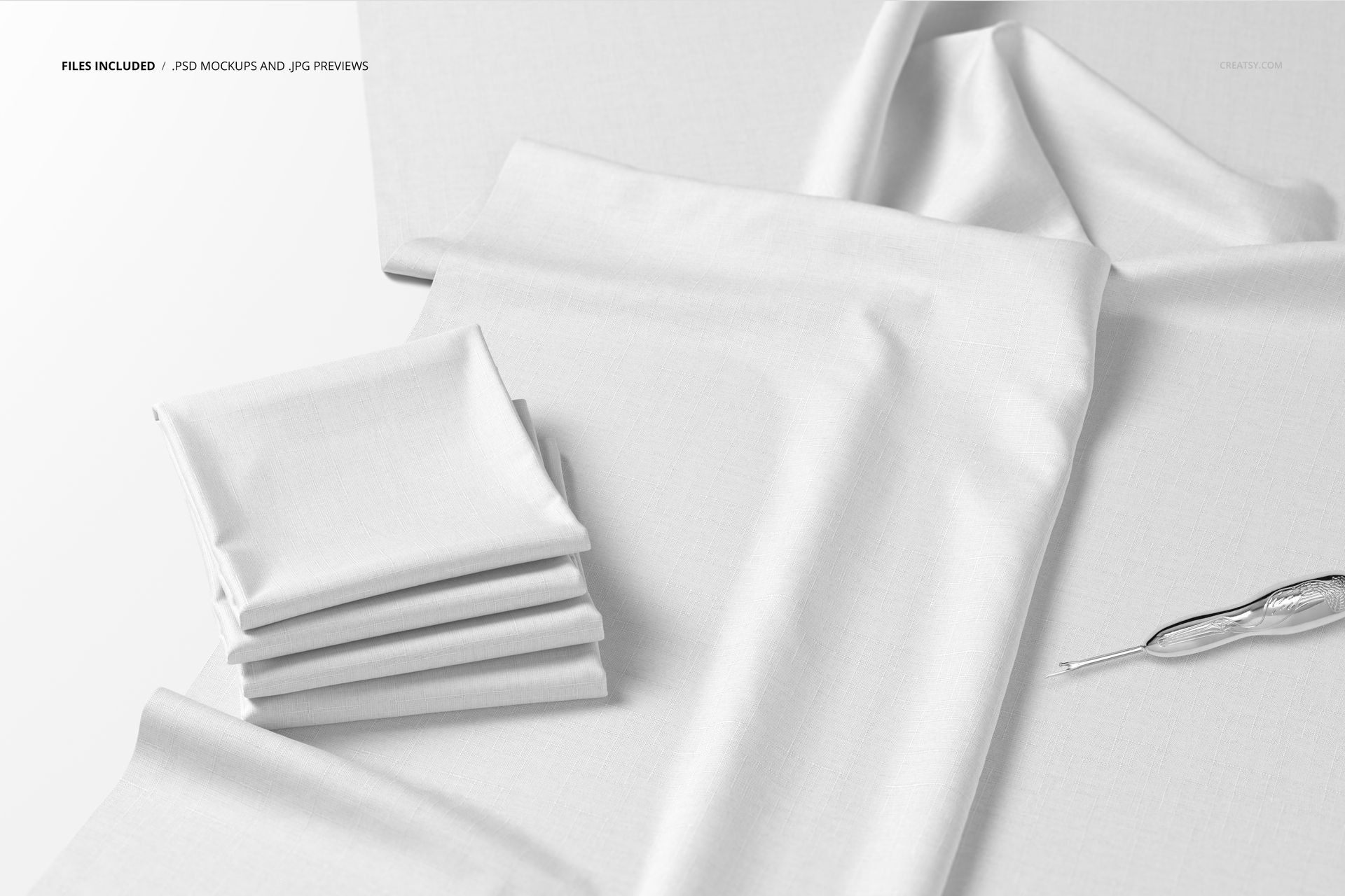 Folded white fabric pieces displayed on a flat surface with a crochet hook, shown from a top view in a mockup scene.