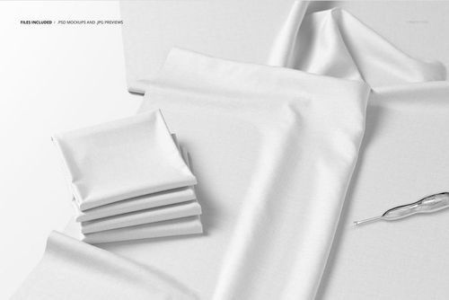 Folded white fabric pieces displayed on a flat surface with a crochet hook, shown from a top view in a mockup scene.