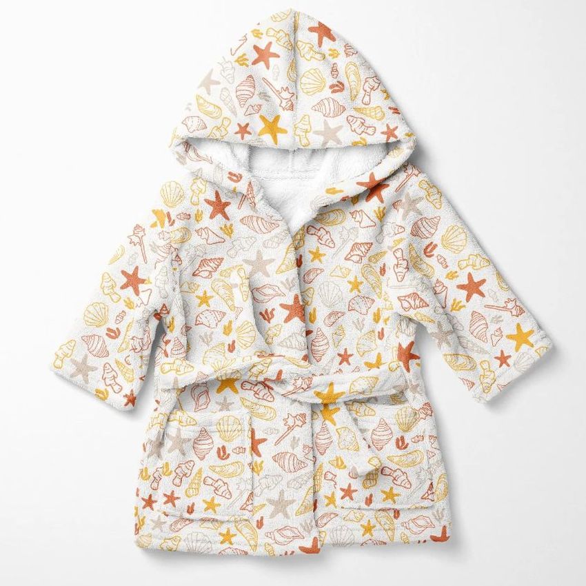 Kids bath dressing gown mockup featuring a hooded robe with orange and yellow seashell and starfish patterns on white fabric.