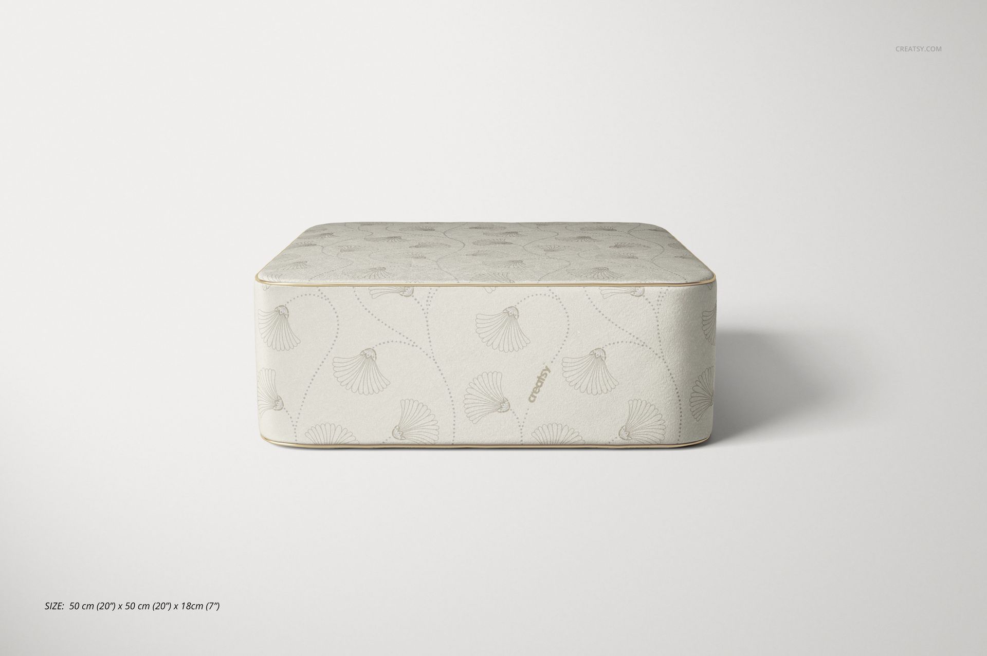 Velvet pouf mockup in a rectangular shape, featuring a light beige color and delicate leaf motifs, front view.