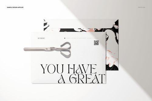 Mockup of tear strip envelopes featuring marble-like designs and large typography, shown with scissors on a white surface.