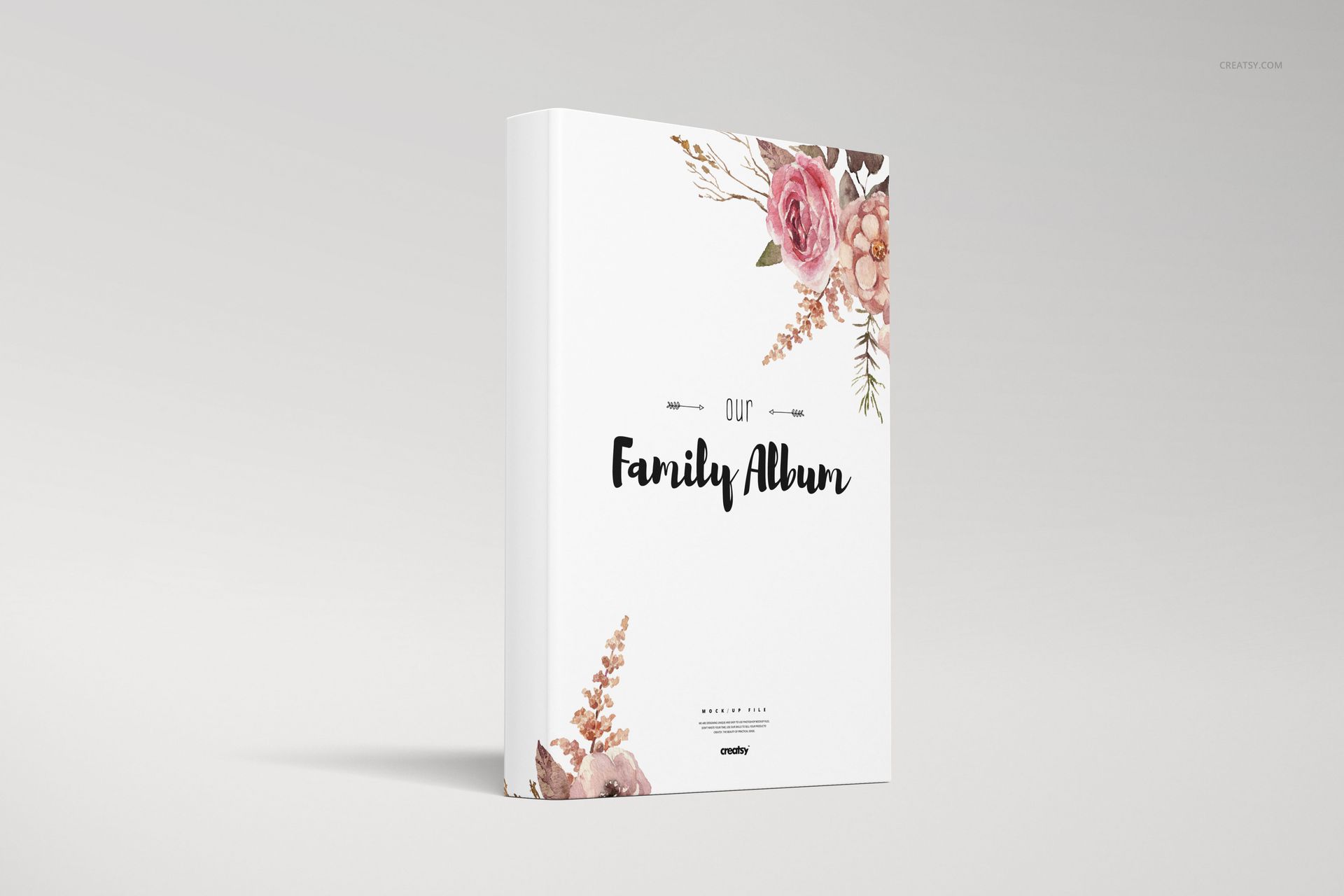 Hardcover family book mockup featuring pink and beige floral artwork on a white cover, displayed on a plain background.