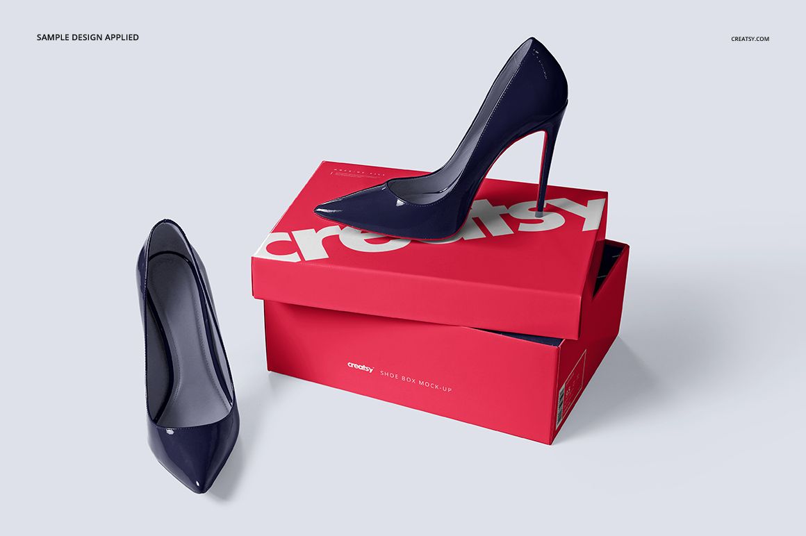 PSD mockup featuring a closed red shoe box with white text and two navy high heels, one on top and one beside the box.