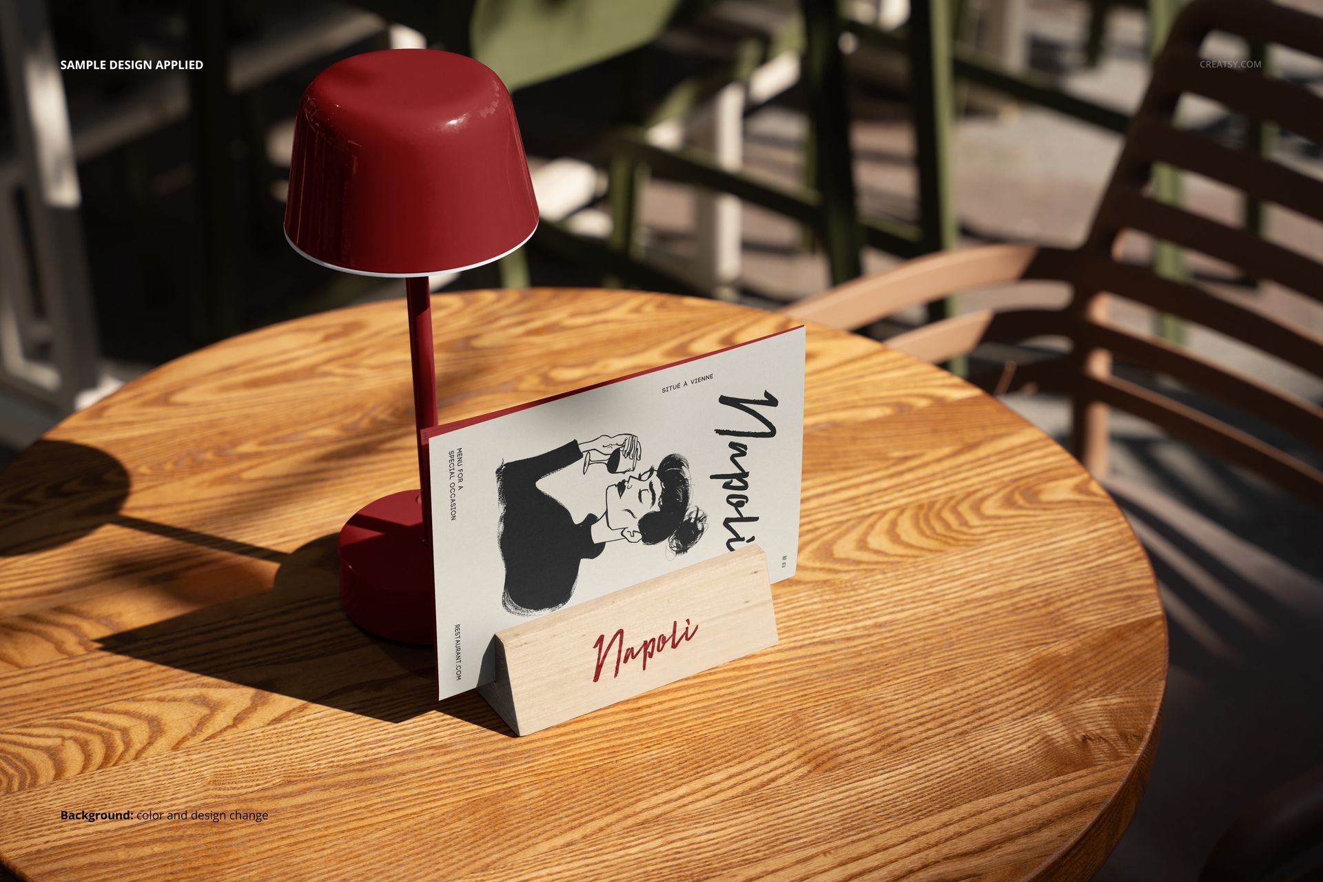 Outdoor restaurant menu mockup displayed on a wooden table with a red lamp and chairs in the background.