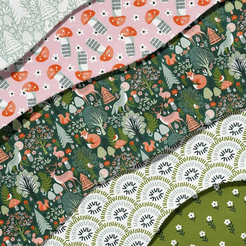 Jersey fabric mockup featuring several torn-edged pieces layered diagonally, each with woodland-themed patterns in green and orange tones.