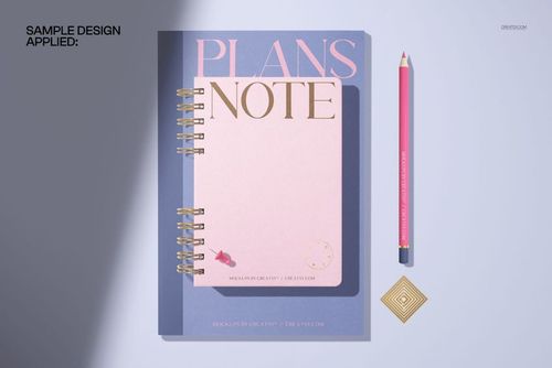 Spiral planner and notebook mockup featuring a pink and purple cover, shown from a top view with a pencil beside it.