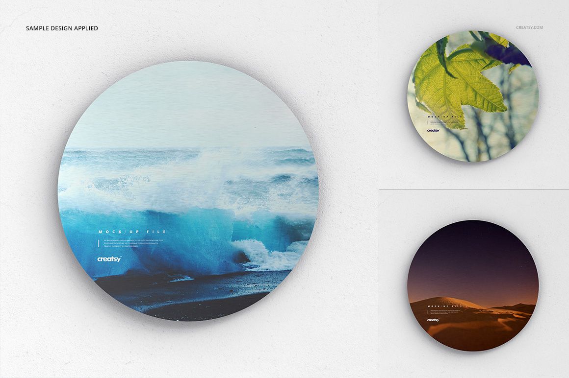 Front view of a metal disk print mockup set with varied artwork, shown against a subtle white textured wall background.