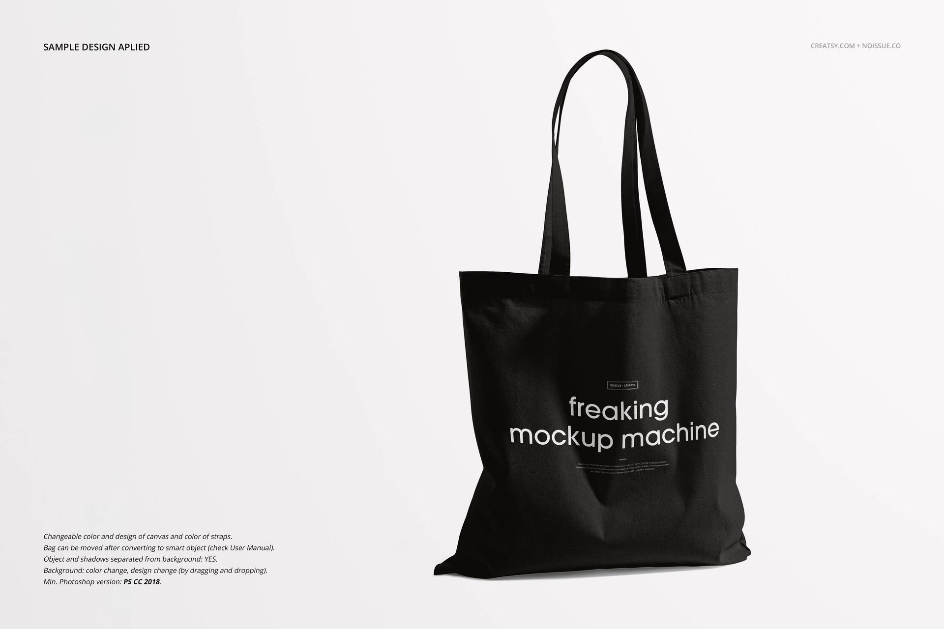 Front view of a black tote bag mockup with long handles and white lettering, set on a minimal white backdrop.