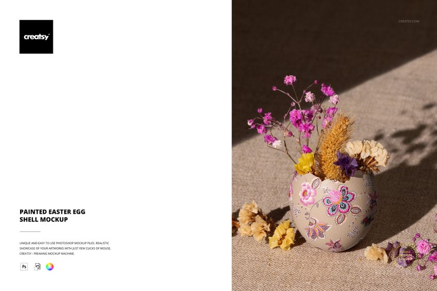 Decorative Easter egg shell mockup with painted floral patterns, filled with dried pink flowers and grain, on beige fabric.