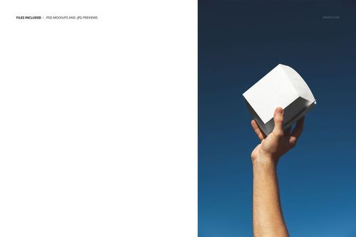 Hand holding a plain white burger box raised against a clear blue sky, packaging mockup with minimal background.