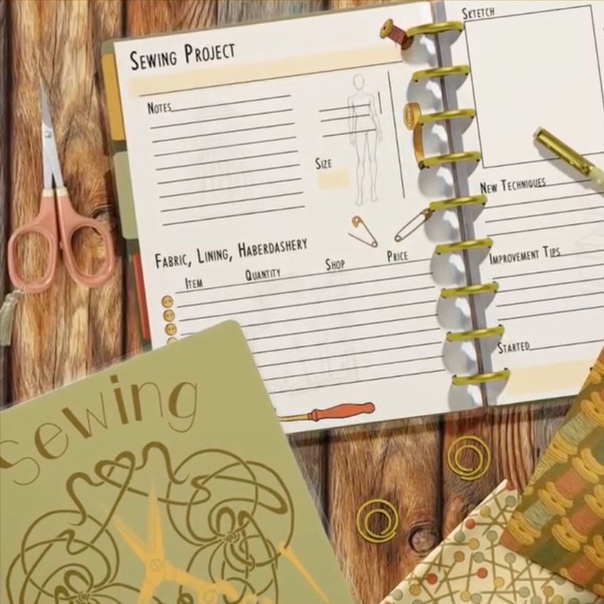 Spiral planner mockup featuring an open notebook with sewing-themed layouts, scissors, and decorative items on a wood background.