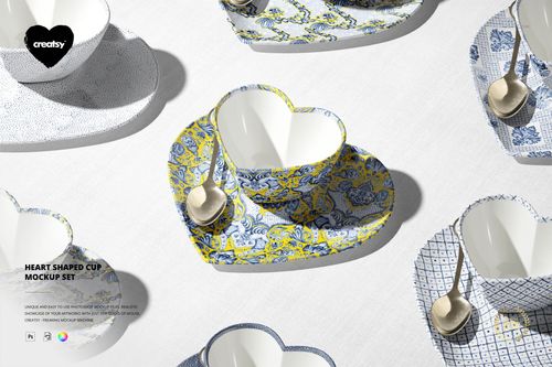 Top view of heart-shaped cup mockup set with patterned saucers and metallic spoons on a light textured background.