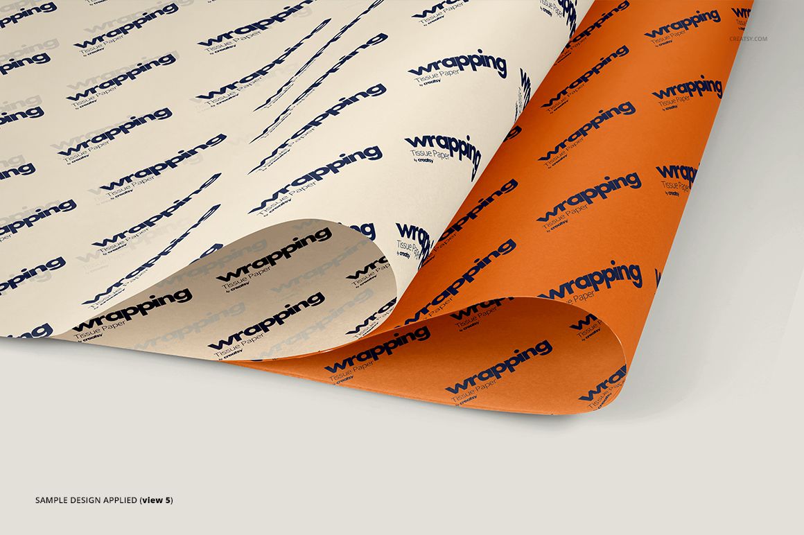 Two sheets of wrapping tissue paper mockup with repeating dark blue text pattern, one cream and one orange, shown at an angle.