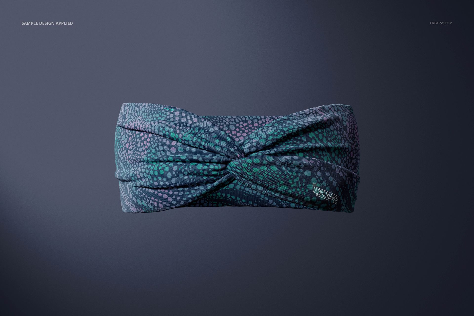 Front view of a faux knot headband mockup displaying a teal and purple dotted design against a dark backdrop.