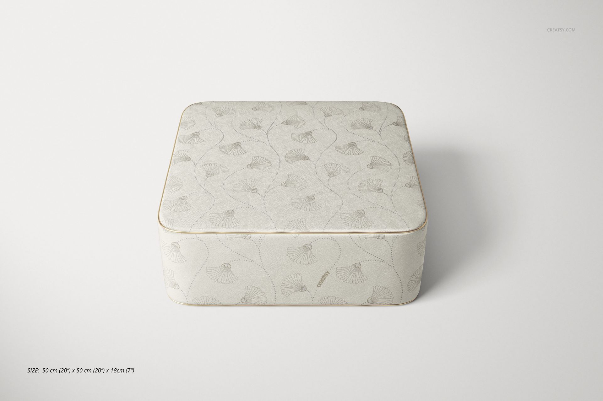 Velvet pouf mockup featuring a soft square cushion with pale botanical design, displayed on a plain white surface.