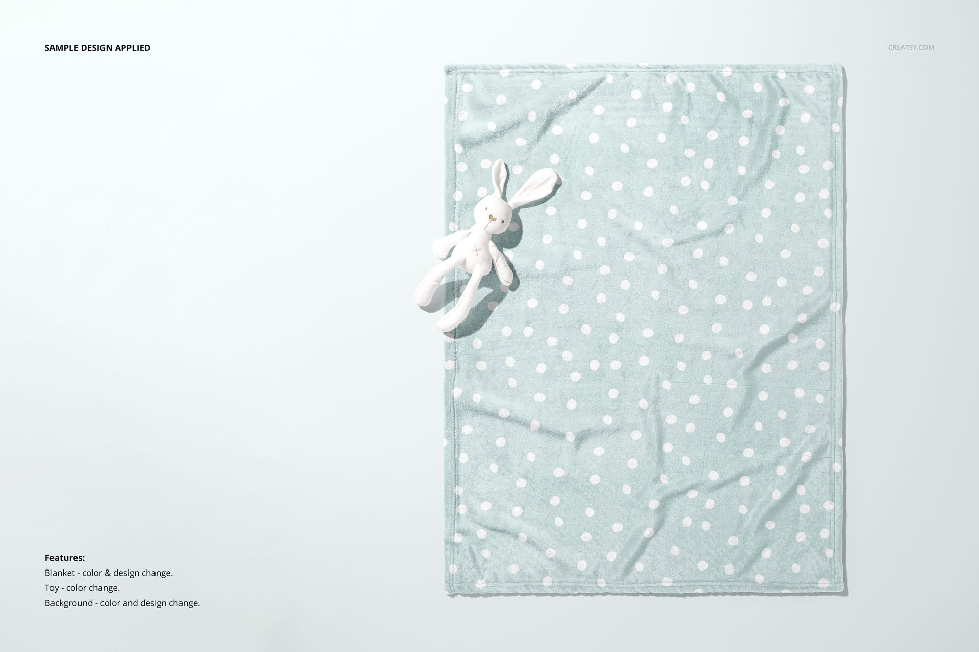 Top view of a 30x40 fleece blanket mockup with a pastel polka dot pattern and a soft bunny toy as a prop.