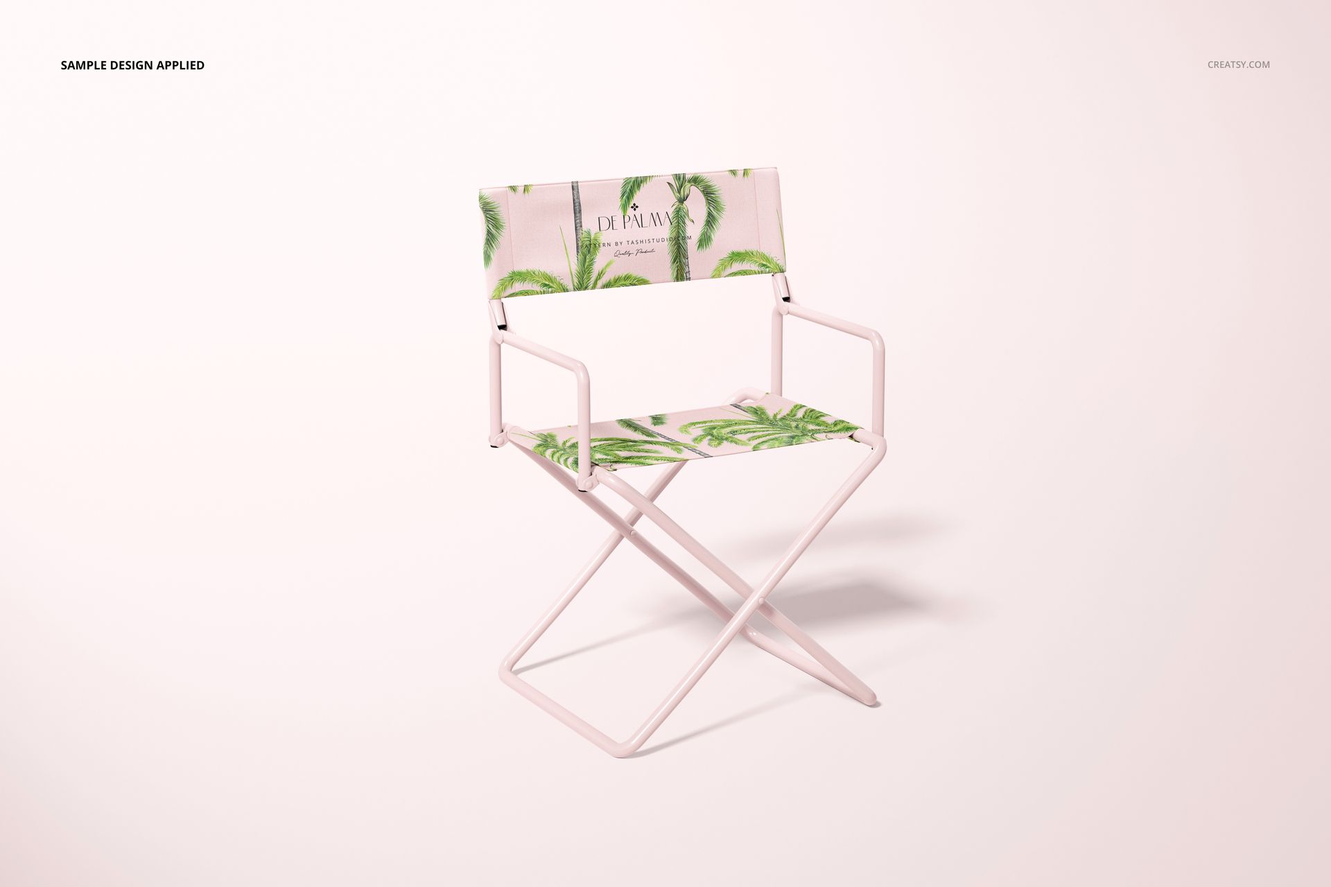 Front-facing director's chair mockup featuring pastel pink frame and green palm leaf print, isolated on white.