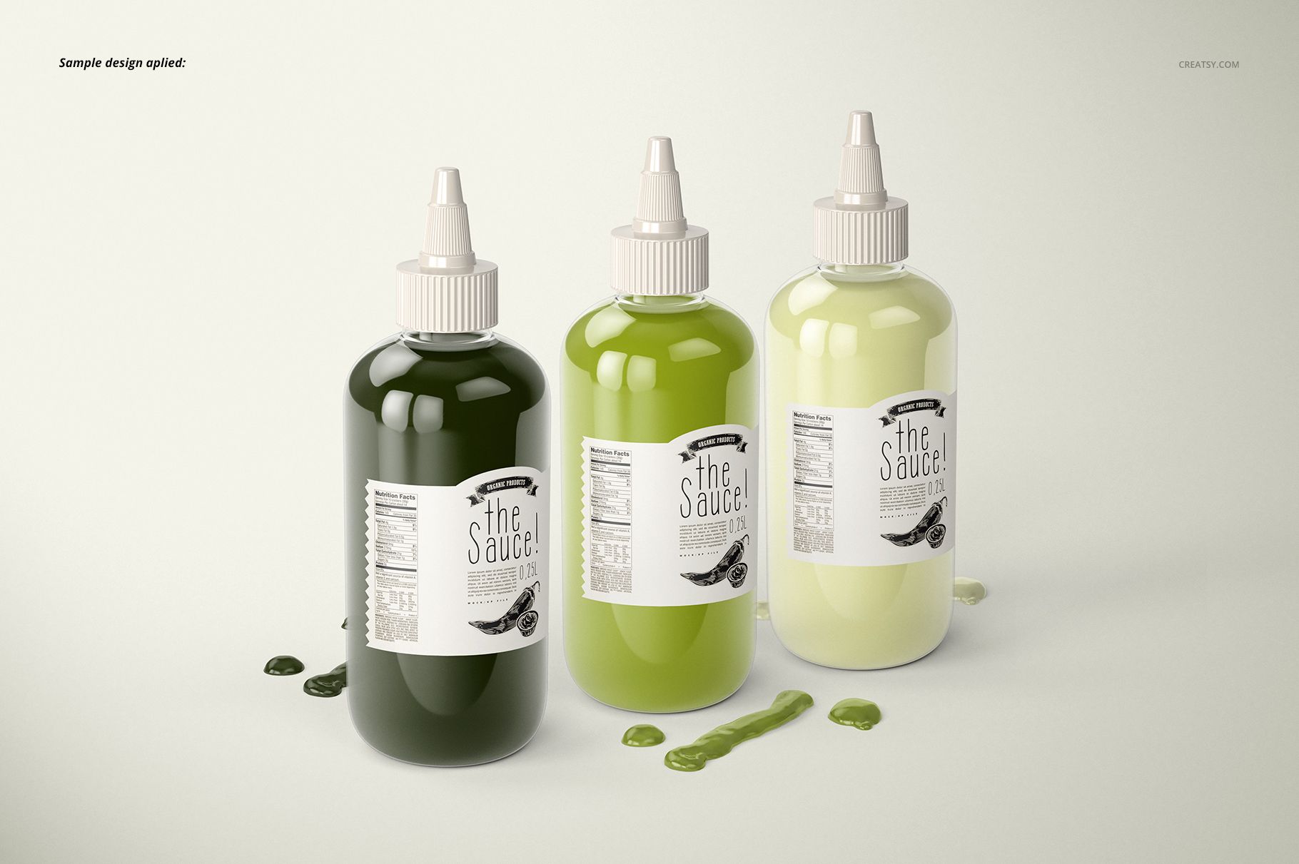 PSD mockup featuring three labeled sauce bottles with white lids, surrounded by small pools of spilled green sauce.