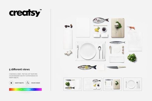 Top view of seafood restaurant table mockup with fish, plate, utensils, cutting board, and fresh ingredients on white background.
