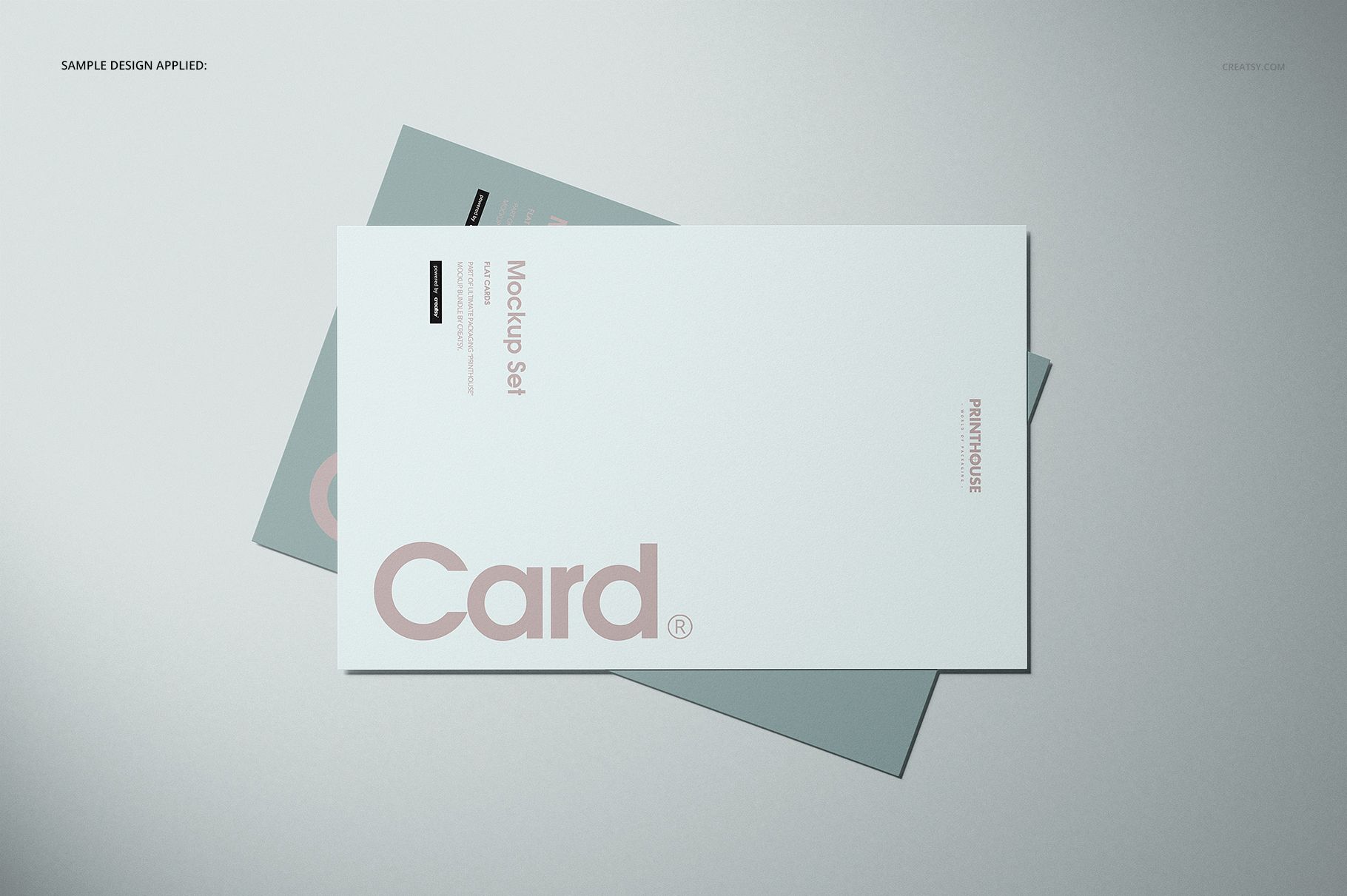 Flat cards mockup with overlapping white and green cards on a light gray background, viewed from above.