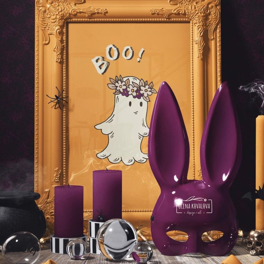 Halloween picture frame mockup featuring a cute ghost illustration with a flower crown and 'Boo!' text, surrounded by purple candles and a purple bunny mask.