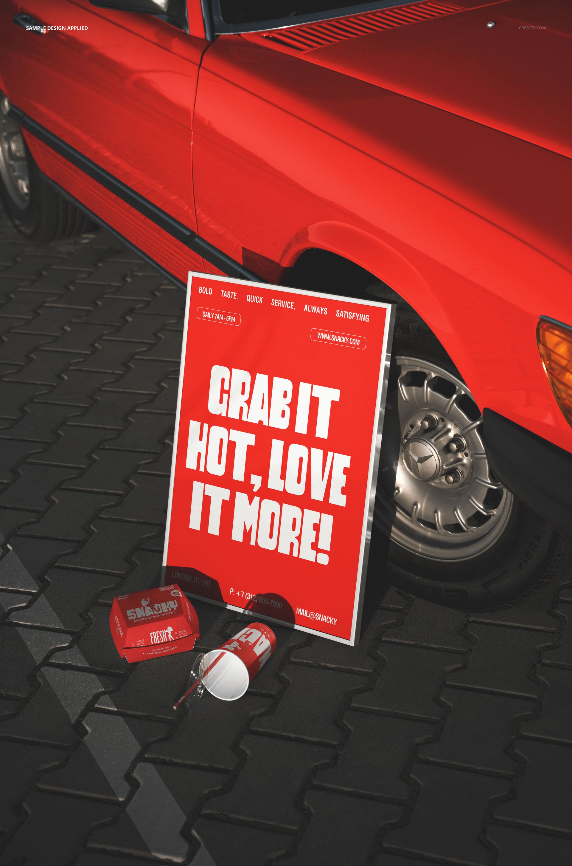 Red fast food burger packaging, drink cup, and poster mockup displayed beside a red car on a paved surface.