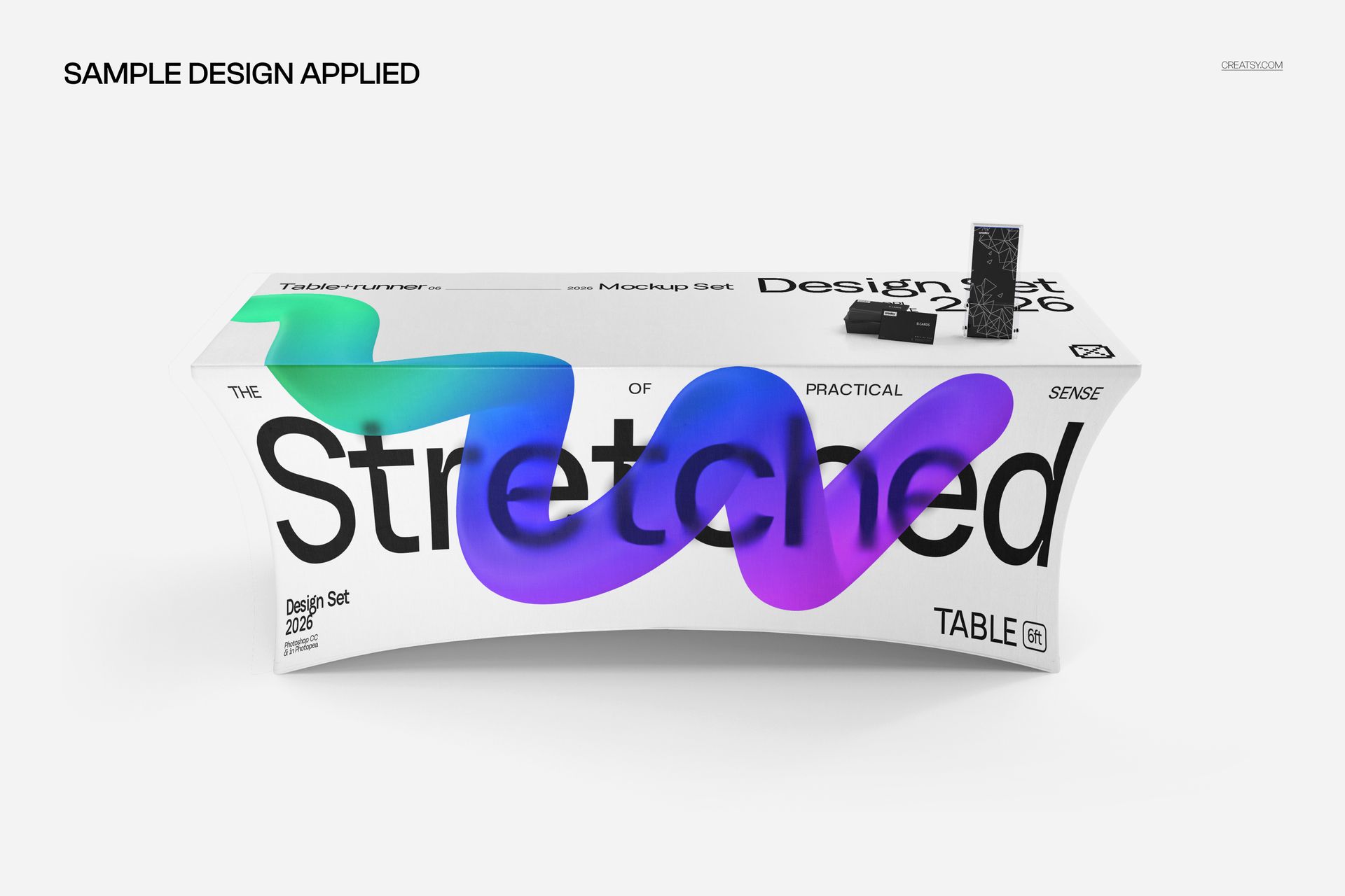 Custom stretched tablecloth mockup featuring large black text and colorful curved graphics, displayed in a studio setting.